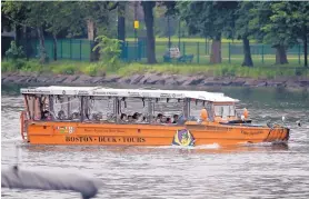  ?? STEVEN SENNE/ASSOCIATED PRESS ?? A duck boat, a replica of a World War II-era amphibious vehicle, makes its way along the Charles River between Boston and Cambridge, Mass., on Sunday.