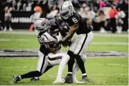  ?? Sam Morris/Getty Images ?? Texans wide receiver Nico Collins gets sandwiched by a couple of Raiders during Sunday’s game in which Collins injured his groin.