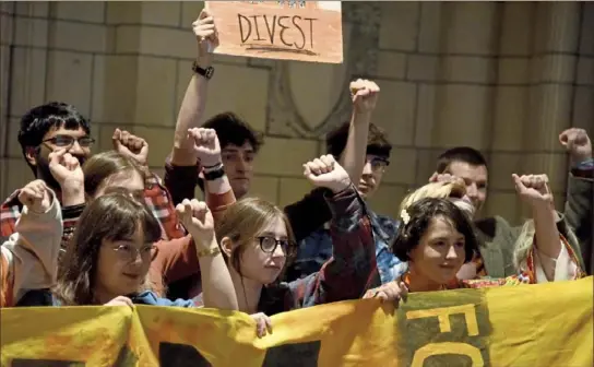  ?? Darrell Sapp/Post-Gazette ?? Members of the Fossil Free Pitt Coalition start their protest in the Cathedral of Learning on Friday on the campus in Oakland.