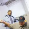  ?? Post-Gazette ?? Zane Gates, an internist, examines a patient in his Altoona office.