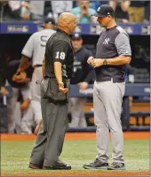  ?? Tampa Bay Times/tns ?? New York Yankees manager Aaron Boone talks with Vic Carapazza, the home plate umpire, after Carapazza ejected Yankees pitcher CC Sabathia from a game last season.