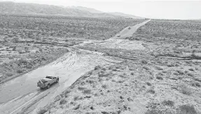  ?? JAY CALDERON/ USA TODAY NETWORK ?? Vehicles stop on Dillon Road about a mile east of Thousand Palms Canyon Road in the Coachella Valley in California after heavy rain deposited mud and rocks there, making the road largely impassable.