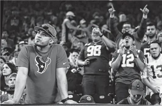  ?? Brett Coomer / Staff photograph­er ?? Against the background of cheering Colts fans, a Texans fan wonders what might have been as the clock winds down during the fourth quarter Saturday at NRG Stadium.