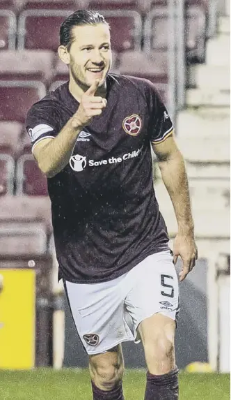  ??  ?? 0 Peter Haring celebrates after scoring Hearts’ third, his first goal since April last year