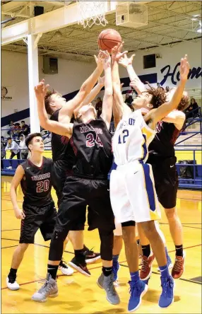  ?? Westside Eagle Observer/MIKE ECKELS ?? Tafari James (Decatur 12) and a host of Warriors fight over a loose ball during the Decatur-Life Way basketball contest in Decatur Nov. 28. Life Way defeated Decatur in the second round of the Decatur Holiday Hoops basketball tournament.