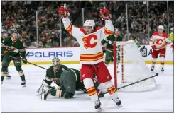  ?? CRAIG LASSIG — THE ASSOCIATED PRESS ?? Calgary Flames left wing Johnny Gaudreau celebrates his goal on Minnesota Wild goalie Cam Talbot during the second period of Thursday’s game in St. Paul, Minn.