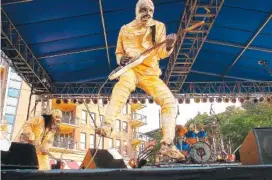  ?? STAFF FILE PHOTO ?? The guitar player and leader of Here Come the Mummies flies through the air on stage during a past Riverbend. The group is performing Saturday at AT&T Field.