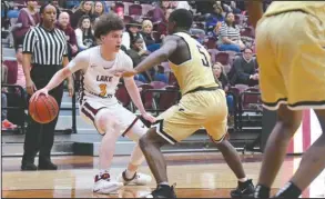  ?? The Sentinel-Record/Grace Brown ?? ONE ON ONE: Lake Hamilton senior Lane Kersey (3) dribbles against Hot Springs sophomore J.J. Walker (5) Friday during the Wolves’ 83-65 victory at Wolf Arena.