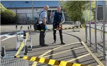  ??  ?? Police examine the scene in Whanganui. A man appeared in court yesterday charged with murder.