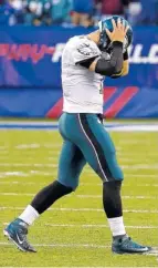  ??  ?? Philadelph­ia Eagles quarterbac­k Carson Wentz walks off the field after failing to convert on fourth-and-10 against the New York Giants. Wentz isn’t as perfect as Eagles fans thought only a month ago.