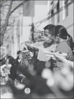  ?? PHOTOS PROVIDED TO CHINA DAILY ?? From left: A robot helps serve a customer at Shotamuni, a Japanese restaurant in Beijing; workers from the Meizhou Dongpo restaurant sell vegetables outside the business; produce from restaurant owners, florists and vegetable sellers is selected at an outdoor market held every weekend in Beijing’s Sanlitun area.