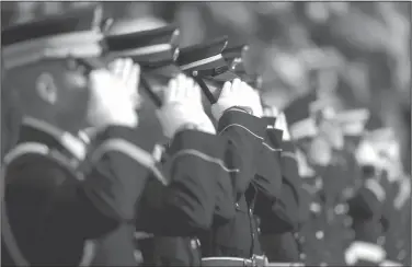  ?? AP Photo/Nam Y. Huh ?? Honor: Military personnel salute during pregame ceremonies before an NFL football game between the Chicago Bears and Detroit Lions on Sunday in Chicago.