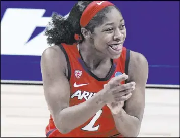  ?? Morry Gash The Associated Press ?? Arizona guard Aari McDonald celebrates after hitting one of her six 3-pointers Saturday in the Wildcats’ 74-59 win over Texas A&M at the Alamodome.