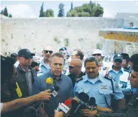  ?? (Reuters) ?? PUBLIC SECURITY MINISTER Gilad Erdan (left) and Israel Police Commission­er Insp.-Gen. Roni Alsheich speak to the press at the Western Wall last June 10, the first Friday of Ramadan.