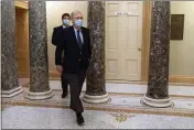  ?? JACQUELYN MARTIN — THE ASSOCIATED PRESS ?? Followed by a staffer, Senate Majority Leader Mitch McConnell of Kentucky, right, leaves the Capitol on Capitol Hill in Washington on Tuesday.