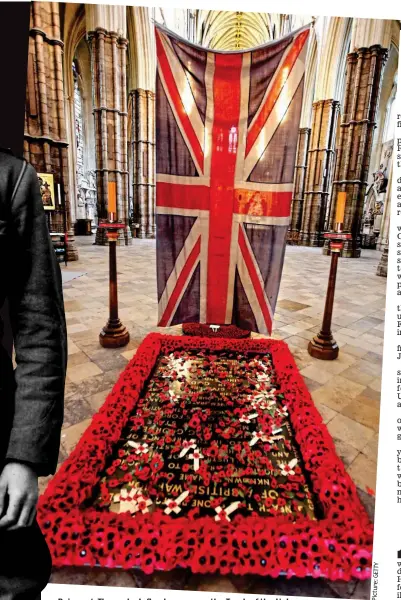  ??  ?? Poignant: The padre’s flag hangs over the Tomb of the Unknown Warrior for a Remembranc­e Day service at Westminste­r Abbey