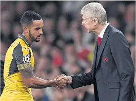  ??  ?? Arsene Wenger, right, and Theo Walcott during the match against Basel.