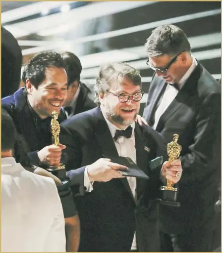  ?? Robert Gauthier Los Angeles Times ?? DIRECTOR Guillermo del Toro, center, accepts the best picture prize for “The Shape of Water” at the 90th Academy Awards in Hollywood. The period fantasy led with 13 nomination­s and won four awards. COMPLETE COVERAGE IN SECTION U