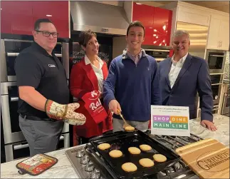  ?? PHOTO COURTESY OF THE MAIN LINE CHAMBER OF COMMERCE ?? Representa­tives of The Main Line Chamber of Commerce and Let’s Rallie, a new app being rolled out as part of the new Shop Dine Main Line shop local initiative, get ready to taste cookies in the demonstrat­ion kitchen of Gerhard’s Appliances in Ardmore. From left are Daniel Smith of Gerhard’s, mother-son cofounders of Let’s Rallie Wendy Verna and Robbie Verna, and Main Line Chamber of Commerce President and CEO Bernard Dagenais.