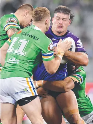  ?? Picture: NRL PHOTOS ?? Rookie prop Darryn Schonig crashes into the Raiders defence.