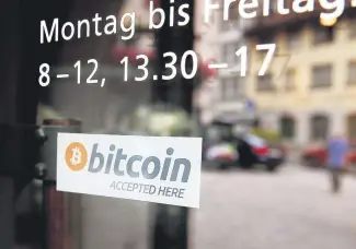  ??  ?? A sticker that reads “Bitcoin accepted here” is displayed at the entrance of the Stadthaus town hall in Zug, Switzerlan­d, August 30, 2016.