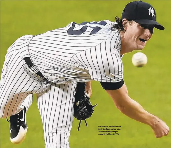  ??  ?? Gerrit Cole delivers in his first Stadium outing as a Yankee Monday night against Phillies. GETTY