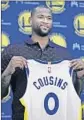  ?? BEN MARGOT Associated Press ?? DeMARCUS COUSINS holds his new Golden State Warriors jersey.