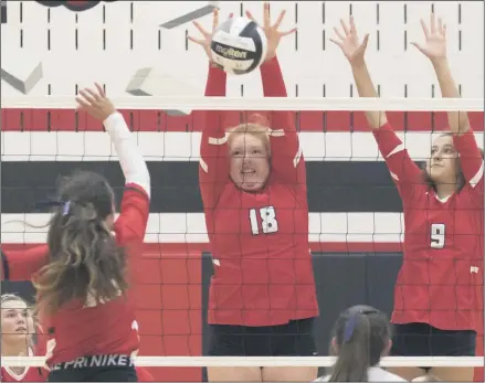  ?? JENNIFER FORBUS - FOR THE MORNING JOURNAL ?? Falcons Lauren Valerius (18) and Shawny Hess go vertical to block a shot from Cardinal Rachel Seekins.