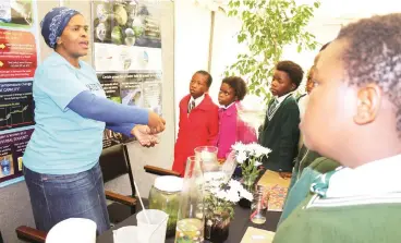 ?? Photo: Sue Maclennan ?? Naniswa Nyoka from the South African Instutute for Aquatic Biodiversi­ty speaks to school children about the importance of looking after water sources, and conserving water, at the Waterworld exhibit area at Scifest yesterday.