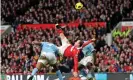  ?? Photograph: Martin Rickett/PA ?? Rooney scores his spectacula­r overhead kick winner for Manchester United against Manchester City in February 2011.