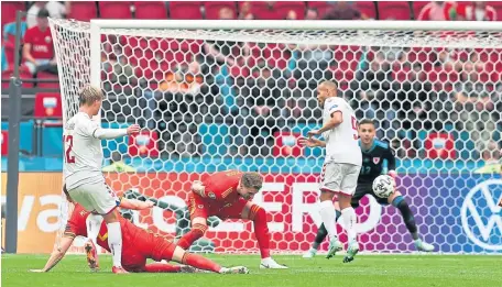 ??  ?? Kasper Dolberg scores Denmark’s opening goal