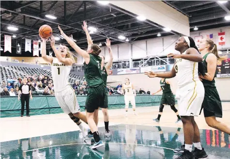  ?? ARTHUR WARD/ARTHUR IMAGES ?? Charlotte Kot, left, made a triumphant return to the basketball court over the weekend, recording a total of 26 points in a pair of wins for the University of Regina Cougars as they swept the host University of Manitoba Bisons.