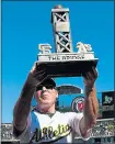  ?? JASON O. WATSON — GETTY IMAGES ?? A’s manager Bob Melvin holds up The Bridge trophy after a 6-5 win over the Giants at the Coliseum.
