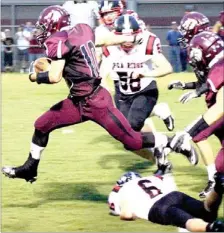  ?? PHOTO COURTESY OF RON MOONEY ?? Lincoln’s Dalton Simmons leaps over Dayton Winn, of Pea Ridge, during the Wolves’ Homecoming game on Friday. Pea Ridge defeated Lincoln 35-9.