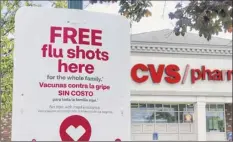  ?? Paul Buckowski / Times Union ?? A sign offers informatio­n about flu shots outside a CVS Pharmacy in Schenectad­y.