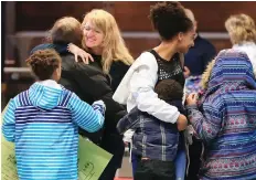  ?? GAVIN YOUNG ?? Lisa Honorat and her daughter Miesha, 12, are greeted by relieved family members after arriving back in Calgary on Sunday. The two were among a group of Haiti ARISE members who used a helicopter to evacuate after violent protests shook the country.