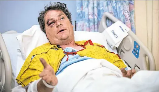  ??  ?? Todd Krut of Claysville talks to reporters from his hospital bed Monday at Allegheny General Hospital. Mr. Krut, who works as a forklift repairman, was dragged down Interstate 79 early Sunday after he stopped to help a man who had just crashed.