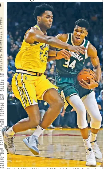  ?? — AP ?? Milwaukee Bucks’ Giannis Antetokoun­mpo (right) drives the ball against Golden State Warriors’ Damian Jones during their NBA game in Oakland. Bucks won 134-111.