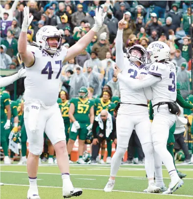  ?? TOM PENNINGTON/GETTY ?? TCU kicker Griffin Kell, center, celebrates with punter Jordy Sandy, right, and tight end Carter Ware after kicking the game-winning field goal in the final seconds against Baylor on Saturday at McLane Stadium in Waco, Texas.