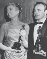  ??  ?? 1955: Grace Kelly’s icy green satin gown was designed by Edith Head and was a turning point for Oscars fashion.