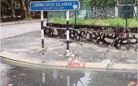  ??  ?? Water overflowin­g from a clogged drain in Taman Tun Dr Ismail, Kuala Lumpur.