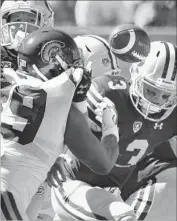  ?? Wally Skalij Los Angeles Times ?? USC LINEMAN Christian Rector forces California quarterbac­k Ross Bowers (3) into a fumble.