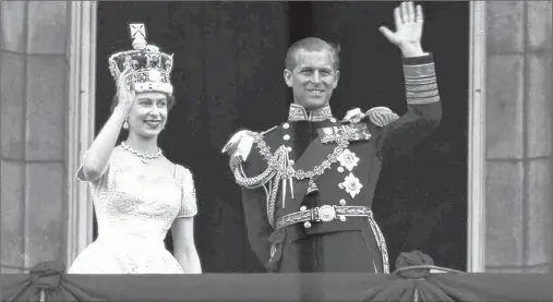  ?? LESLIE PRIEST/AP FILE PHOTO ?? In this June 2, 1953 file photo, Queen Elizabeth II and Prince Philip, Duke of Edinburgh, wave to supporters from the balcony at Buckingham Palace, following her coronation at Westminste­r Abbey. Philip retired from solo official duties on Wednesday at the age of 96.