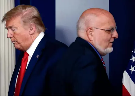  ?? AP ?? President Donald Trump passes Dr Robert Redfield, director of the Centres for Disease Control and Prevention, during a briefing about the coronaviru­s at the White House last month. Trump has been criticised for relegating the CDC to a ‘‘nominal’’ role.