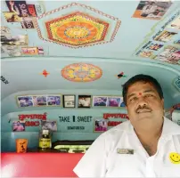  ?? AFP ?? Sandeep Bachche, a rickshaw driver and fan of Bollywood actor Sanjay Dutt, poses for a picture inside of his three-wheeler which is covered with posters of the actor, in Mumbai on Friday. —