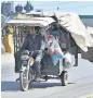  ?? APP ?? A rickshaw driver carrying different items to a market in Barakahu in Islamabad. —