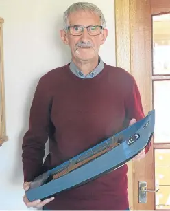  ?? Picture: Angus Whitson ?? Tom Easton holding a miniature version of one of his salmon fishing cobles.