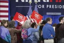  ?? DAVID YEAZELL — THE ASSOCIATED PRESS ?? Attendees wave campaign signs at an event for Republican presidenti­al candidate and former U.N. Ambassador Nikki Haley on Monday in Greer, S.C.