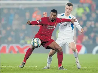  ?? Picture: ANDREW YATES/REUTERS ?? UNSTOPPABL­E: Liverpool’s Georginio Wijnaldum, left, in action against Genk’s Bryan Heynen during the Champions League Group E match at Anfield, Liverpool, on Tuesday