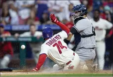  ?? LAURENCE KESTERSON - THE ASSOCIATED PRESS ?? Phillies shortstop and 10th inning “runner on second” Ronald Torreyes is safe at home on an RBI single by Jean Segura before New York Yankees catcher Gary Sanchez, right, can apply the tag at Citizens Bank Park on Saturday.